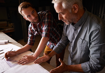 Image showing Carpenter, team and men with blueprint for discussion of construction project or father teaching son. Engineer, apprentice and senior mentor with design, drawing and planning for training at workshop