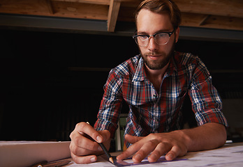 Image showing Man, pencil and architect drawing blueprint, construction and civil engineering with stationery in workshop. Design tools, paperwork and closeup of floor plan for property development or renovation