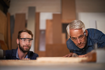 Image showing Wood, father and son in workshop, teamwork or renovation with drawing or safety glasses with planning for project. Parent, men or teamwork with construction or building with problem solving or choice