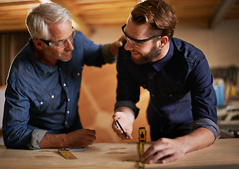 Image showing Architecture, teamwork and senior mentoring man in workplace of workshop, pencil and drawing. Male people, professional and working with measuring tape on wooden table for planning of renovation