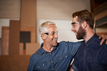 Image showing Man, hug and smile with wood, workshop and family business or apprenticeship. Mature father, son and embrace with artisan, carpentry and together for startup and mentor or learning with happiness