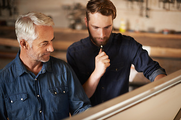 Image showing Planning, discussion and architects by board in workshop for industrial carpentry project. Brainstorming, engineering and male industry apprentice working on ideas with mentor in office on site.