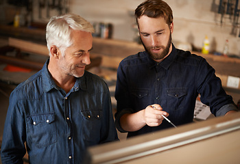 Image showing Brainstorming, discussion and architects by board in workshop for industrial carpentry project. Planning, engineering and male industry apprentice working on ideas with mentor in office on site.