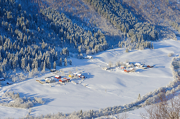 Image showing Pristine winter wonderland in a mountainous village at dawn