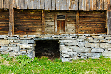 Image showing Rustic charm of an ancient stone foundation barn at twilight