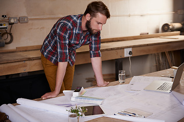 Image showing Man, check blueprint and architect with engineering or construction, renovation project and design for building. Floor plan, sketch and property development with assessment of paperwork in workshop