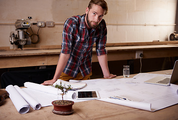 Image showing Man, portrait and architect with floor plan for engineering or construction, renovation and design for building. Blueprint, sketch and property development with architecture paperwork in workshop