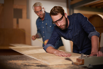 Image showing Wood, father and son in a workshop, architect and carpenter with renovation or safety glasses with protection. Parent, men or teamwork with construction or building with planning for project or gear