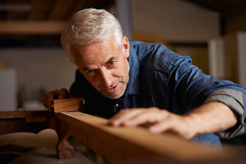 Image showing Carpenter, mature man and wood for manufacturing in workshop, industry and company of construction. Entrepreneur, male person and professional in garage or shop for startup and small business