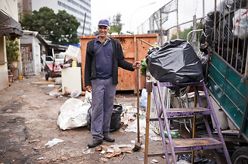 Image showing Man, working and cleaning of garbage for waste management in city with portrait, broom and happiness. Person, face and smile by dumpster site for scrap, recycling and trash in neighborhood for litter