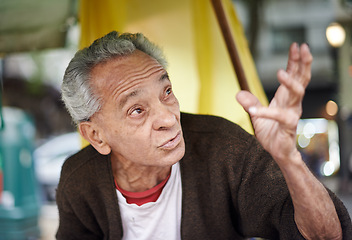 Image showing Conversation, city and elderly man on journey in a neighborhood outdoor with chat and communication. Urban, sitting and senior Mexican male person with wisdom, street and road with travel and advice