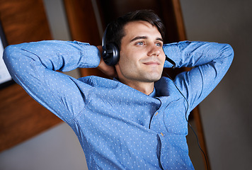 Image showing Businessman, headset and listening music in office professional, smile and relax for break. Male person, resting or peaceful and enjoying podcast in workplace, salesman and formal outfit indoors