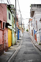 Image showing Houses, barrio and street in city with architecture, color and slum with buildings on urban road. Neighborhood, favela and apartment with expansion, home and ghetto housing project in Sao Paulo