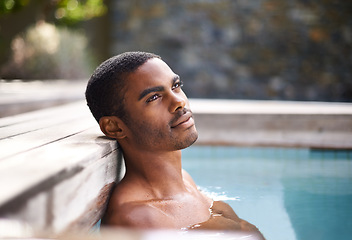 Image showing Thinking, pool and water with African man, vacation and holiday outdoors to relax in sunshine. Summer, swimming and happiness for body wellness, calm person and weekend entertainment and ideas