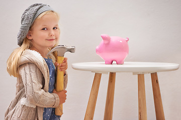 Image showing Girl, hammer and piggy bank in portrait for money, finance and investment for future in home. Female person, child and waiting for profit or wealth, cash growth and tool to break a money box to spend