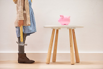 Image showing Girl, hammer and piggy bank for savings or money, finance and investment for future in home. Female person, child and waiting for profit or wealth, cash growth and tool to break a money box to spend