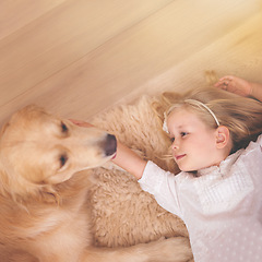 Image showing Girl, dog and relax together for bonding, care and pet for support on floor of living room in home. Child, golden retriever and stroke a puppy on mockup space, top view and companion in childhood