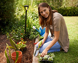 Image showing Woman, portrait and gardening for agriculture in backyard with garden shovel, happiness and sustainability. Gardener, person and green fingers with plants and flower for growth or eco friendly hobby