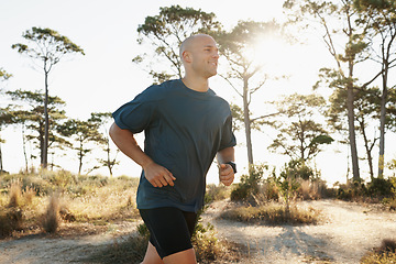 Image showing Fitness, running and man on road in forest for health, wellness and strong body development. Workout, exercise and runner on path in nature for marathon training, performance and morning challenge.