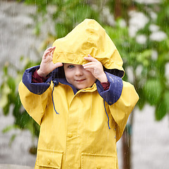 Image showing Winter, rain and portrait of boy with jacket for cold, vacation and happiness with enjoyment in Australia. Little kid, face and smile in nature for weekend, adventure or holiday in gloomy weather