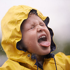 Image showing Child, nature and rain with jacket for freedom, fun and carefree enjoyment in Australia. Droplets, kid and face with tongue out for vacation, weekend or holiday in winter with water protection