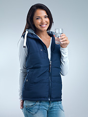 Image showing Woman in portrait, water for health and hydration in studio, nutrition and wellness with drink for thirst on grey background. Liquid, aqua and h2o in glass, fresh and clean for refreshment and detox