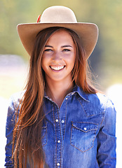 Image showing Cowgirl, portrait and hat at farm, smile and western fashion for agriculture, work and outdoor in summer. Woman, person and farmer at ranch for sustainability, countryside and environment in Texas