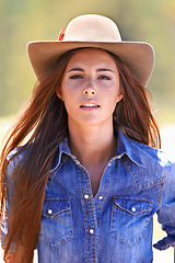 Image showing Cowgirl, portrait and hat at farm, field and western fashion for agriculture, work and outdoor in summer. Woman, person and farmer at ranch for sustainability, countryside and environment in Texas