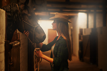 Image showing Cowgirl, happy and woman with horse at barn or stable in Texas for recreation. Western, animal and smile of person at ranch with pet or stallion for hobby with care for livestock at equestrian farm