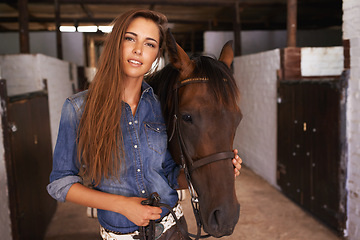 Image showing Cowgirl, portrait and woman with horse at barn or stable in Texas for recreation. Western, animal and face of person at ranch with pet, livestock or stallion for hobby with care at equestrian farm