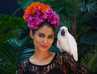Image showing Jungle, portrait or woman with flowers or parrot, natural cosmetics for wellness in nature aesthetic. Smile, animal or female Indian model in rainforest for skincare beauty, pet bird or floral art