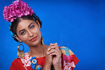 Image showing Beauty, cosmetics and portrait of woman with makeup in blue background of studio with shine and glow of skin. Happy, girl and smile of female person with results of face routine for aesthetic