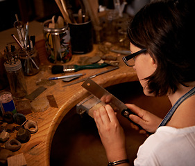 Image showing Woodworking, artist and tools in hands at workshop with creative project or sculpture at night. Artisan, carpenter and woman with talent for creativity in dark studio in process of carving wood