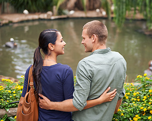 Image showing Couple, hug and love or together at zoo, relationship and care on outdoor adventure or holiday. People, back and embrace on vacation and romance at sanctuary, date and calm or peace on weekend trip