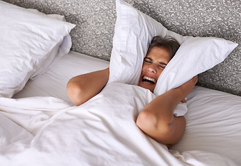 Image showing Woman, noise or insomnia in bedroom to rest, tired or cover ears with pillow for crisis of loud background. Lady, frustrated and mad for sound or sleep problem, anxiety and headache or stress in home