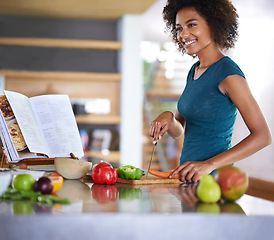 Image showing Cooking, happy woman and cutting vegetables with recipe book in kitchen for healthy diet, nutrition or lunch. Chopping board, food or African person preparing salad for dinner or organic meal in home