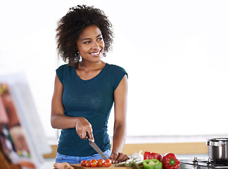 Image showing Cooking, happy woman and cutting vegetables in kitchen with recipe book for healthy diet, nutrition or mockup. Chopping board, food and African person thinking of dinner or organic meal prep in home