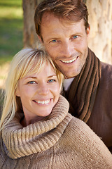 Image showing Couple, park and portrait by tree in embrace, romance and bonding for love at park on weekend. People, care and outdoor date for relationship or marriage, support and hug in nature for commitment