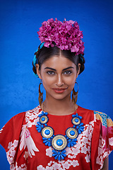 Image showing Beauty, cosmetics and portrait of woman with aesthetic in blue background of studio with shine and glow of skin. Happy, girl and smile of female person with results of face routine for makeup