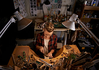 Image showing Woodworking, tools and artist in workshop with creative project or above sculpture on table at night. Artisan, carpenter or person with talent for creativity in dark studio in process of carving wood