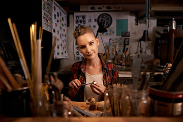 Image showing Portrait, woman and tools with wood in workshop with craftsmanship, knife or handmade design and creativity. Woodwork, carpenter or creative person at workspace with equipment for handicraft or hobby