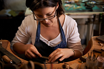 Image showing Carving, wood and artist with tools in workshop for creative project or production of sculpture on table. Artisan, carpenter and woman with talent for creativity in studio in process of woodworking