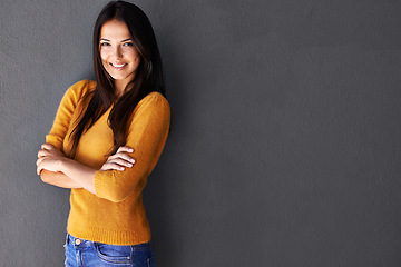 Image showing Portrait, arms crossed and woman in studio, fashion or cool style in gray background. Female person, smile and happy with confidence in mockup space, stylish and edgy in casual outfit or clothes