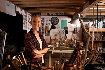 Image showing Artist, studio and portrait of happy woman in workshop to work on creative sculpture or project at night. Artisan, workplace or arms crossed for pride or confidence as carpenter with talent and tools