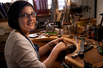 Image showing Artist, working and portrait of woman in workshop for creative wood sculpture or project at night. Artisan, workplace or person with pride or confidence as woodworking carpenter with talent and tools