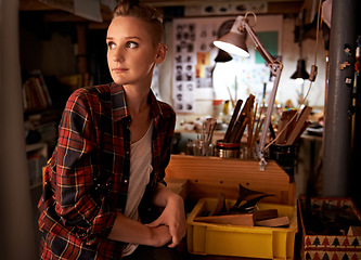 Image showing Artist, thinking and woman in workshop or studio for creative sculpture or working on project at night. Artisan, workplace or person with ideas and inspiration as carpenter with talent for woodwork