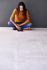 Image showing Tablet, app and woman on a floor with social media, scroll or elearning research on wall background space. Digital, mockup or lady student in a house with ebook search, course or online education