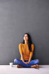 Image showing Woman, peace and relax or breathe in home, calm and cup of coffee on floor of living room. Female person, mockup space and wall background for meditation, hot drink and daydreaming in apartment