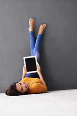 Image showing Portrait, feet up or woman with tablet screen on floor for social media, scroll or search on wall background. Digital, space or person face on ground with google it, sign up or Netflix and chill app