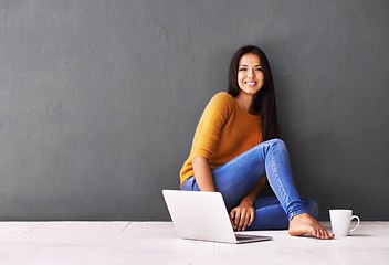 Image showing Woman, laptop and portrait or coffee in home, web and cup of tea on floor of living room. Female person, mockup space and wall background for freelancer, planning and remote work in apartment on app